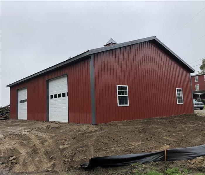 New big red barn with two garage doors