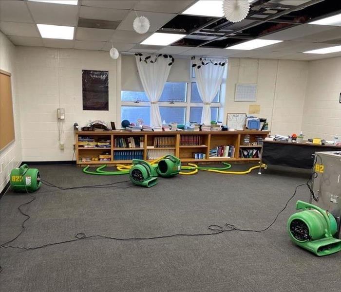 Dehumidifier and air movers set up in a classroom