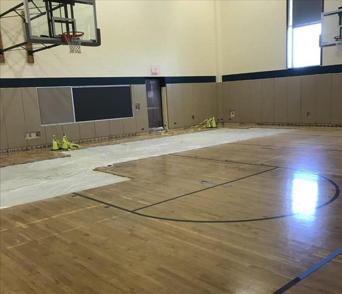 Partial hardwood flooring removed in a elementary school gym