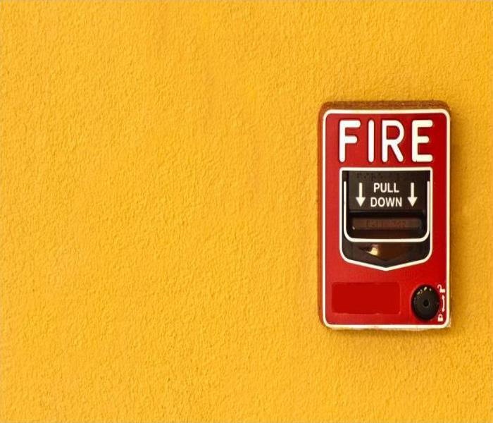 Fire alarm on a yellow wall